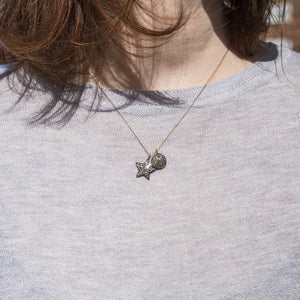 the star paired with the disc from the same collection seen on a model on 18 inch chain