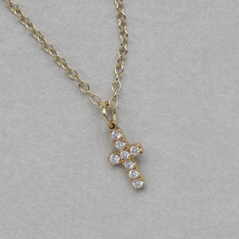 felt tiny diamond cross in yellow or white gold setting