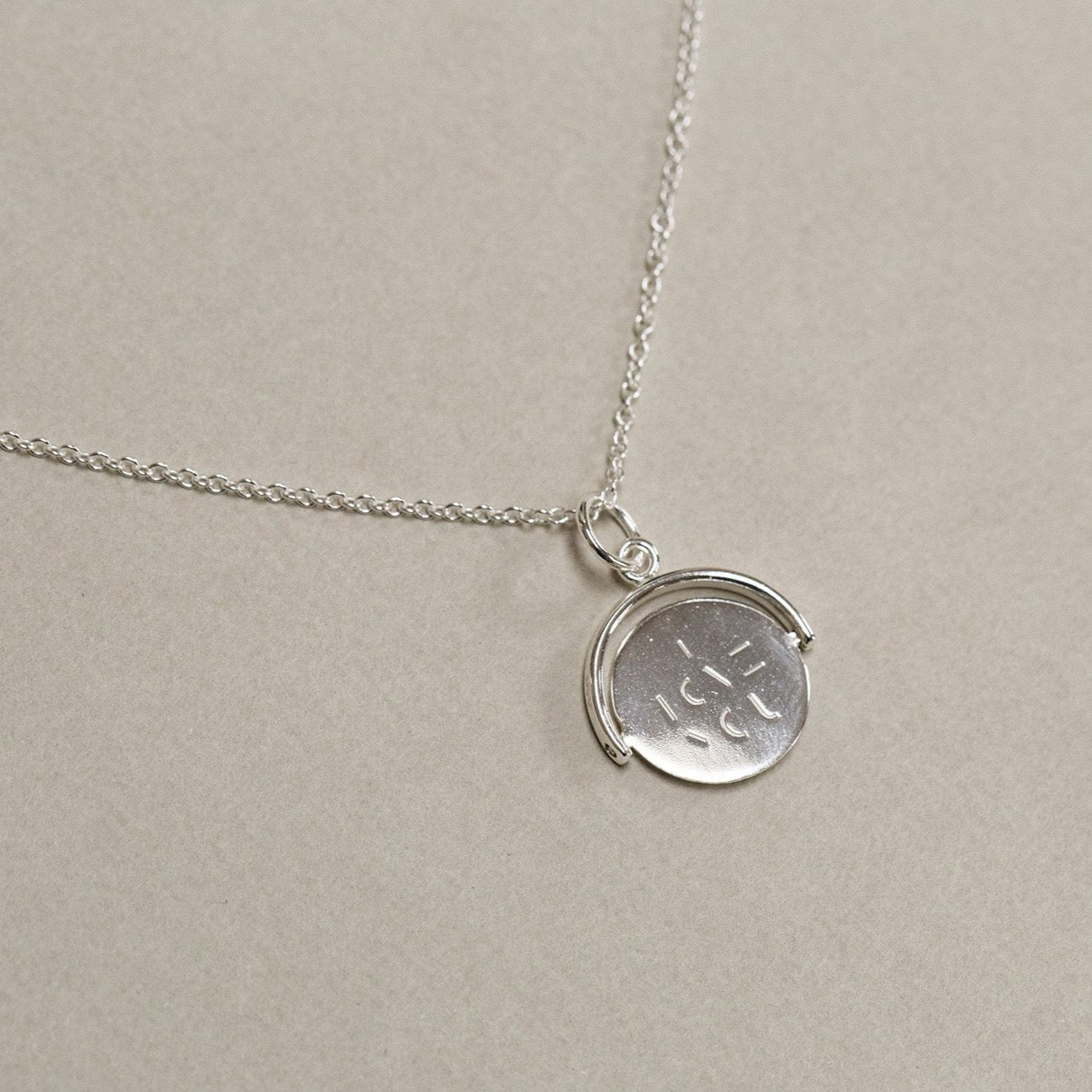 contemporary sterling silver spinning I love you necklace