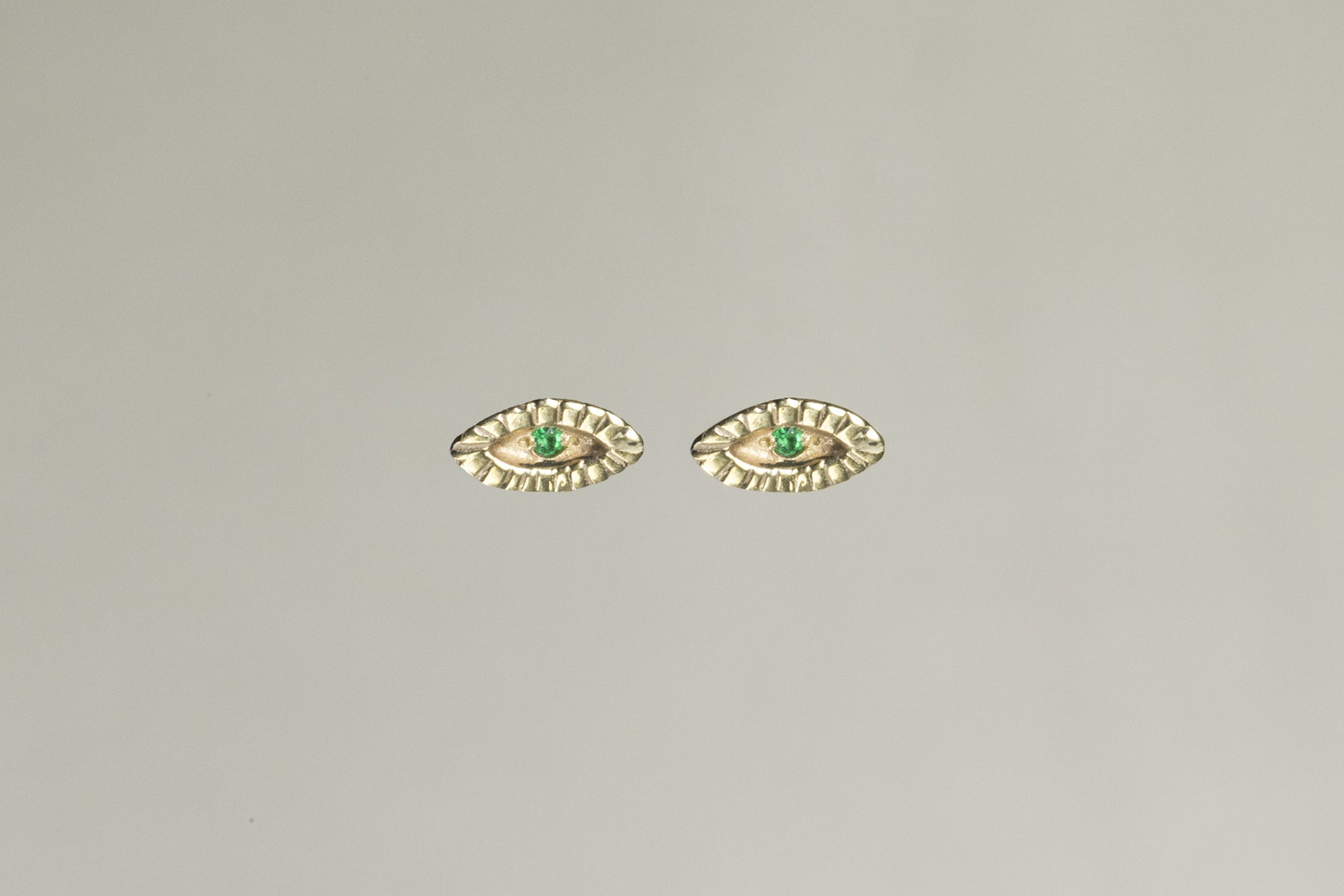 Tiny Eye Gold Stud Earrings with Emerald by Momocreatura