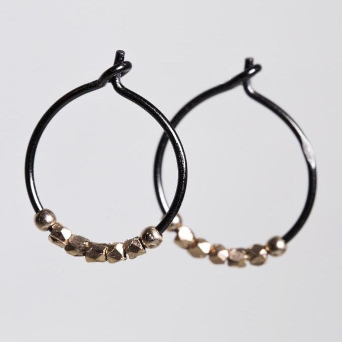 subtle rose gold nugget beads light up the blackened silver hoops