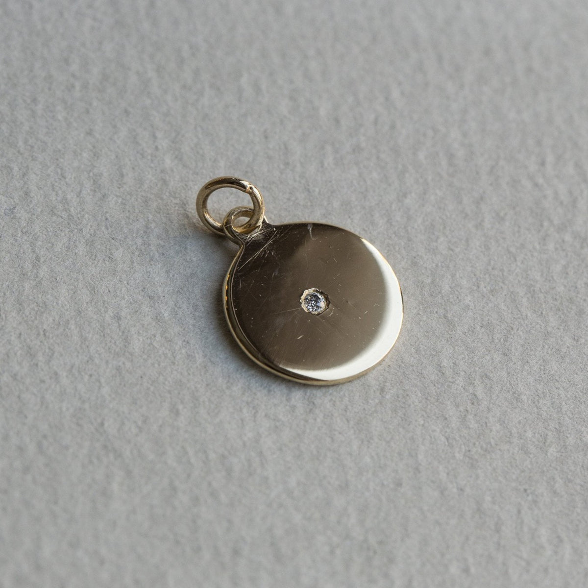 the disc is handmade and it matches our inexpensive 9 carat gold chain also available on feltlondon.com