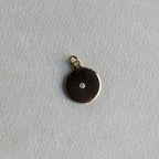 felt's own design - incredibly simple and enchanting polished gold disc with diamond