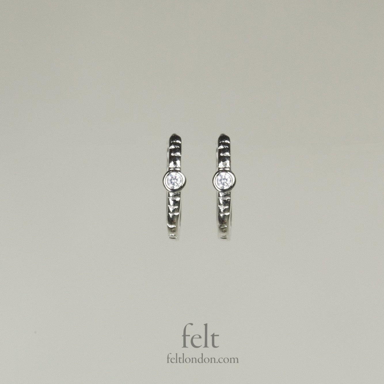 Single stone sleepers in sterling silver with a single cubic zirconia 