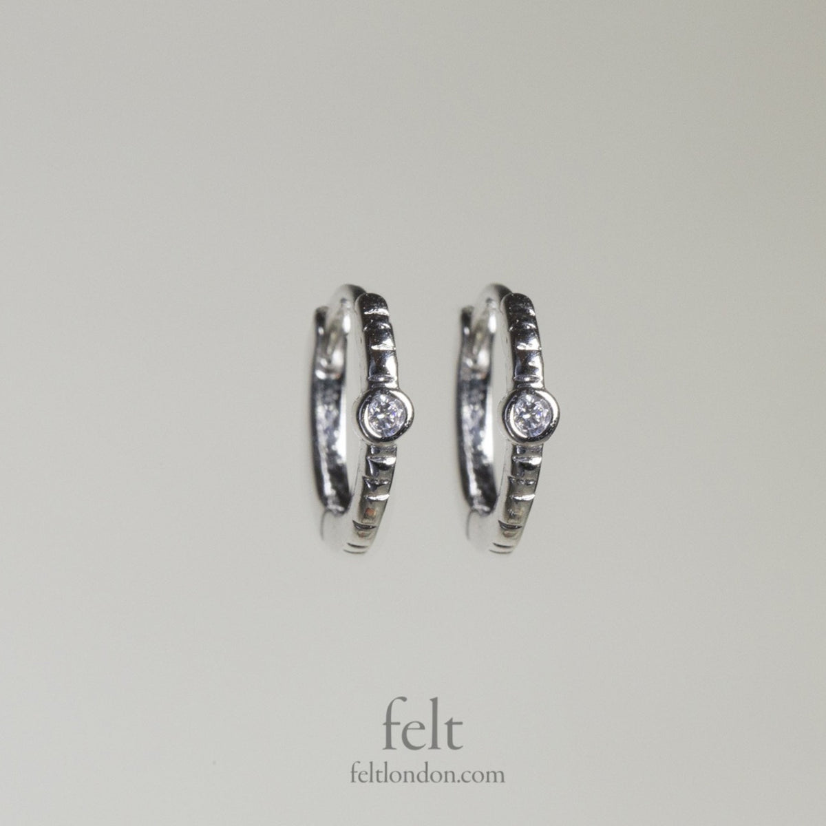 Single stone sleepers in sterling silver with a single cubic zirconia 