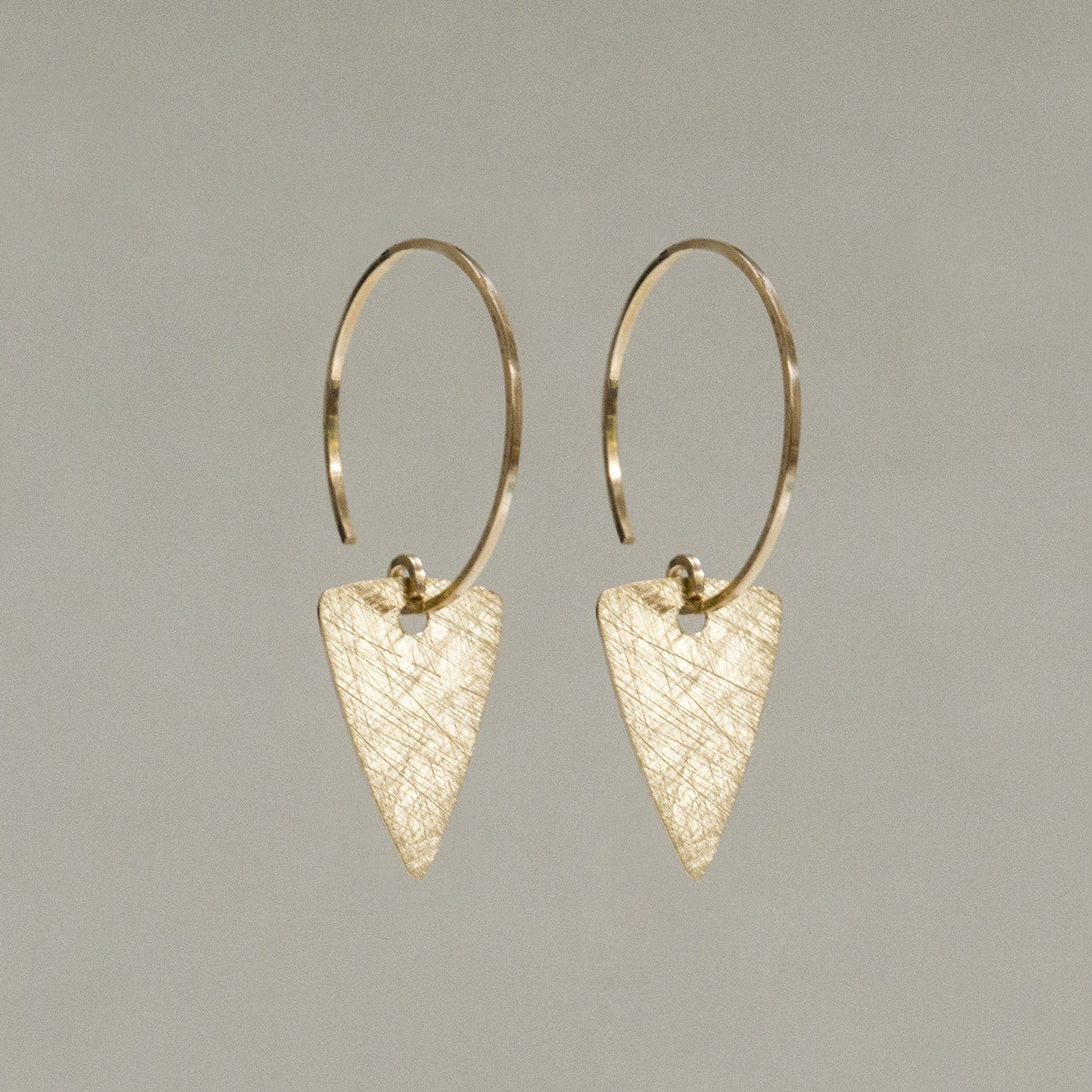 soft but striking arrow head charm hoops