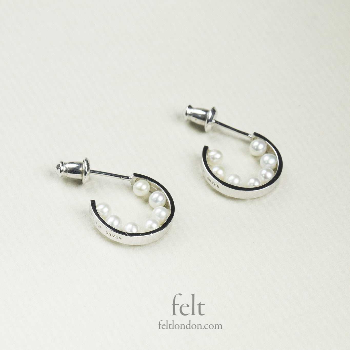 astonishing, pearl lined silver hoops from e.m. Mehem