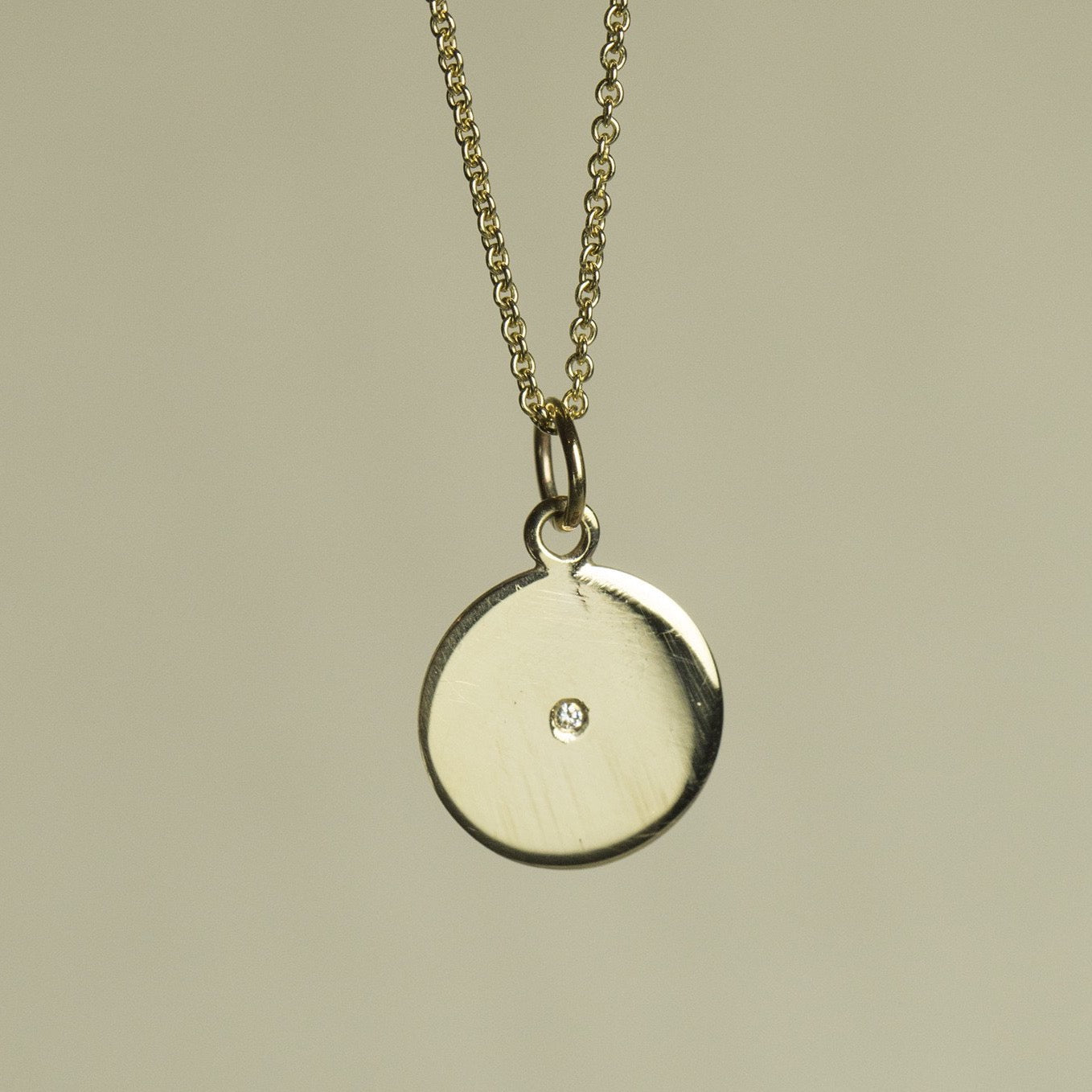 felt's own design - incredibly simple and enchanting polished gold disc with diamond on 9 carat gold chain